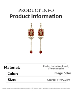 Detail view of retro red resin earrings with pearls and dimensions of 11.0x2.2cm