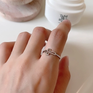 Close-up of minimalist S925 sterling silver hollow cross open ring on finger