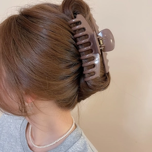 Brown square silicone hair claw clip shown on woman’s hair for stylish updo hairstyle