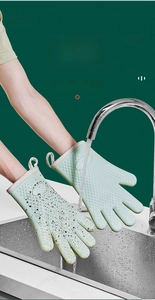 Close-up of mint green silicone cleaning gloves showing waterproof surface and hanging loop