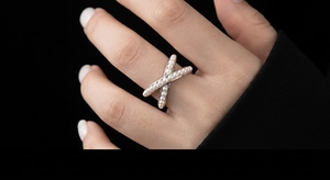 Cross hollow open ring with zircon and pearls on hand model with black background