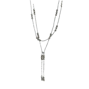 Close-up of a silver double-layered tassel necklace with minimalist bead design
