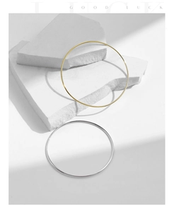 Minimalist S925 sterling silver thin bangles in gold and silver finish on white stone
