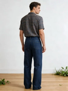 Rear view of men's loose wide-leg jeans in dark blue wash with a vintage relaxed fit