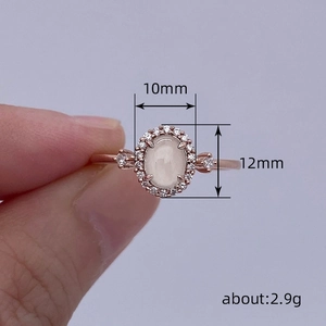 French retro oval opal ring in rose gold with halo setting and side diamonds