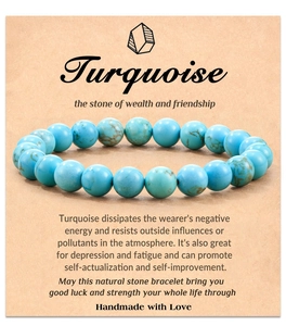Detail of turquoise bead bracelet on card with stone of wealth and friendship text