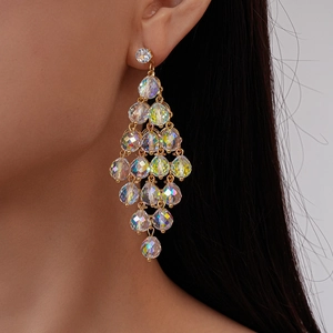 Detail of crystal drop earrings with layered diamond-shaped fringe on a model