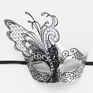 Detail of silver butterfly masquerade mask with sparkling rhinestones and black vine patterns