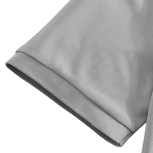 Detail of light gray pique knit polo shirt showing ribbed elastic cuff texture
