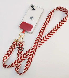 Detail of adjustable phone lanyard with red leaf pattern, pearl charm and gold lobster clasp