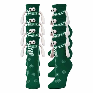Green 3D magnetic hand-holding socks with cartoon eyes and Christmas snowflake patterns