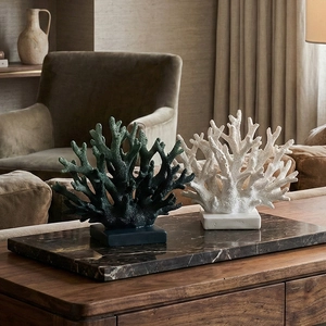 Set of green and white resin coral sculptures on a marble tray for modern home decoration