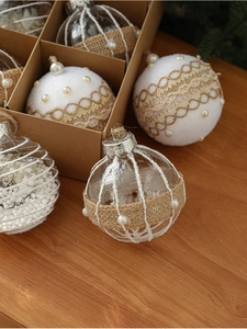 Close-up of vintage Christmas balls with lace, pearls, and white flocking textures