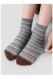 Close-up of grey striped cotton socks for kids showing high elasticity and soft knit fabric