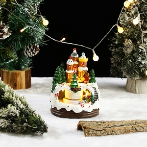 Close-up of a Christmas castle ornament with LED warm lighting and gingerbread man detail