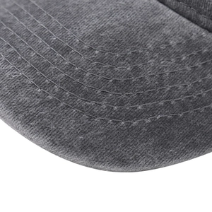 Detailed macro shot of dark grey washed cotton baseball cap brim with parallel stitching