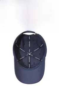 Detail view of the navy baseball cap interior with reinforced brand seam tape