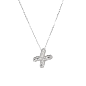 Macro detail of silver X-shaped pendant with cubic zirconia on a minimalist chain