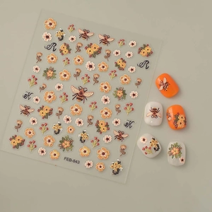 Detail of FEB-843 3D bee and floral nail art stickers applied on manicured tips