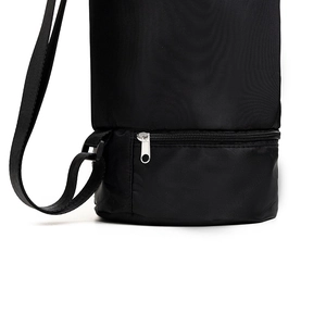 Detail view of the black yoga mat bag base with zipper pocket and adjustable strap