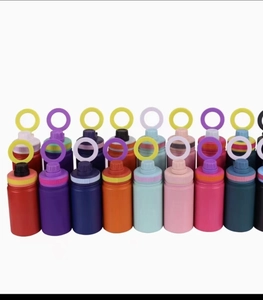 Macro detail of portable sports bottles showing colorful silicone ring handles and caps