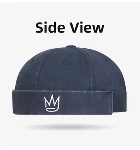 Side view of navy blue denim docker hat with white crown embroidery and folded brim