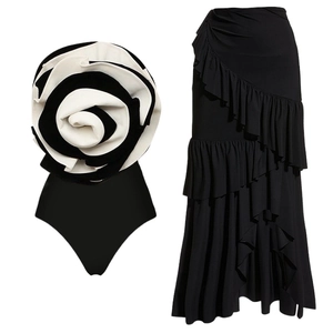 Elegant black swimsuit with 3D white rose detail and matching ruffled maxi skirt set