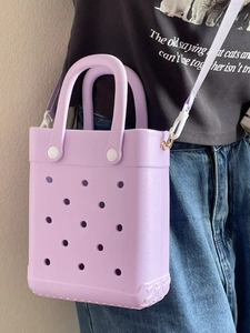 Lavender EVA perforated tote bag with adjustable shoulder strap shown on a model