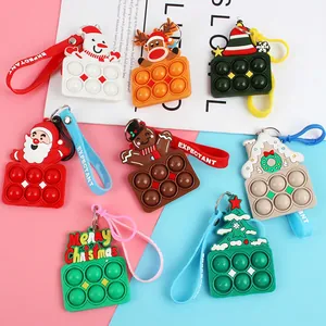 Variety of Christmas Pop-it silicone keychains with Santa and Reindeer designs