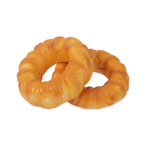 Pair of realistic golden PU squishy donuts with swirl texture on a white background