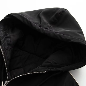 Women's black quilted jacket with hood, metal zipper, and diamond-pattern lining