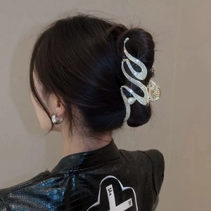 Elegant silver snake claw clip with rhinestones and large pearl on wavy metal frame