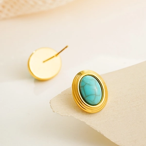 Macro detail of oval turquoise earrings with 18K gold-plated vintage textured metal edges