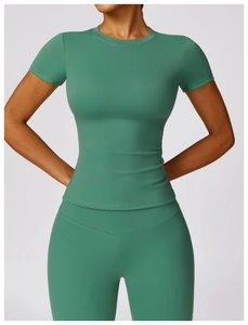 Front view of dark green high-waisted yoga set featuring short sleeve compression top and leggings