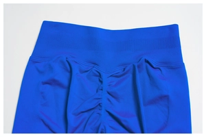Detail of high-waist ribbed waistband and scrunch butt texture on blue yoga pants