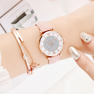 Roségouden horloge met roze band en sterrenhemel wijzerplaat met een sterrenarmband