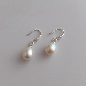 Macro shot of S925 sterling silver stamp on natural teardrop pearl drop earrings