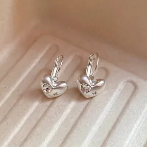 Minimalist matte silver heart earrings with zircon stones and star-shaped engraving detail