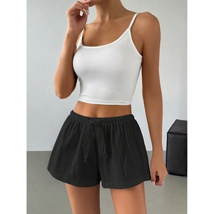 Women's summer athletic set with white ribbed crop top and black drawstring shorts
