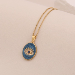 Détail du pendentif œil maléfique doré avec émail bleu et cristaux brillants