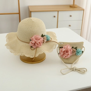 Detail of hand-woven straw hat and flower bag set for girls, perfect for summer sun protection