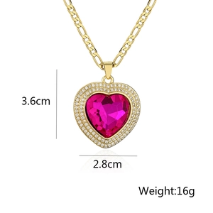 Detail view of pink heart zircon pendant measuring 3.6cm by 2.8cm on a gold Figaro chain