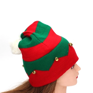 Knitted Christmas elf hat with red green stripes and gold bells on a mannequin