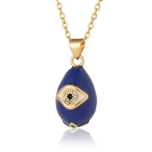 Detailed close-up of blue teardrop Evil Eye pendant with cubic zirconia on gold chain