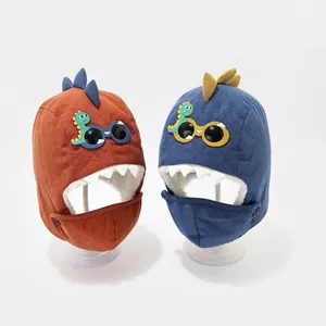 Winter fleece-lined kids dinosaur trapper hats in orange and navy with built-in face masks