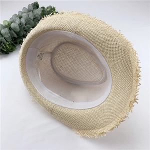 Top view of a beige straw Fedora hat with frayed edges and internal size 58 label