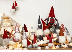 Festive collection of Christmas gnomes in various sizes and colors with cozy warm lighting