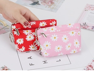 Detail of floral daisy coin purses with zipper, key ring chain, and durable material