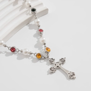 Detail view of silver hip-hop rosary necklace with faux pearls and colorful gemstones