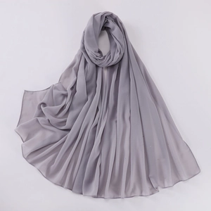 Detailed close-up of grey chiffon shawl fabric with sparkling rhinestone star patterns